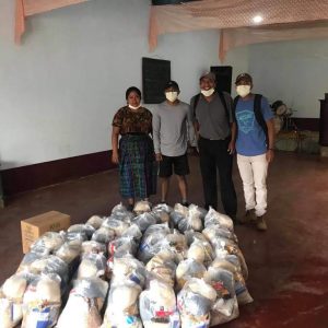 Fernando and his family preparing to distribute bags of food to families in their village