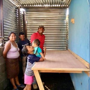 Fernando with Ruth and her family in her new sewing workshop! Fernando designed and built a retractable table for her sewing machine.