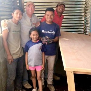 Fernando with Ruth's family in her new sewing workshop! Fernando designed and built a retractable table for her sewing machine.