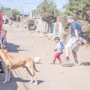 Playing soccer with children on Ruth's street