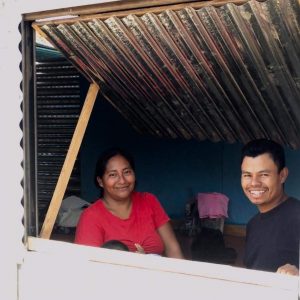 Ruth and her husband, Baltimore, smile from the sales window in her new workshop.