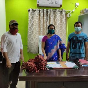 Director Amit Mondal (left)prepares to go out and distribute masks and 