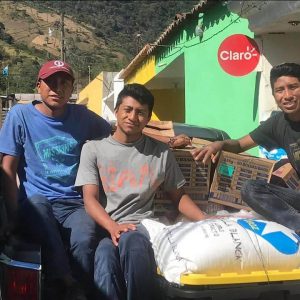 Luis (right) distributes food