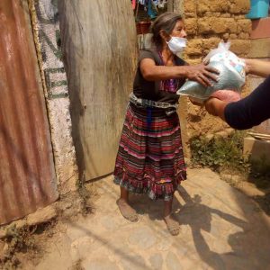 Arecely distributes food to families in her community