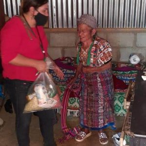 Arecely distributes food to families in her community