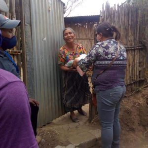 Arecely distributes food to families in her community