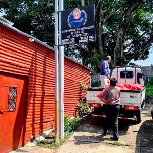 Pastor Marco Tulio loads up a truck with relief packages outside his church in Guatemala City