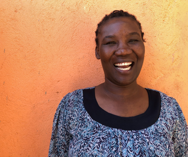A Kenyan woman smiles broadly