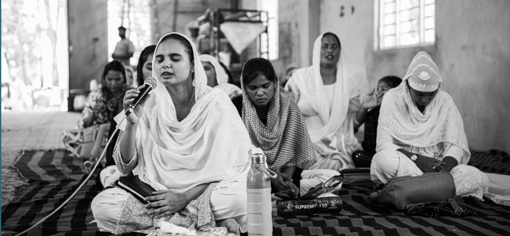 group of women praying in India